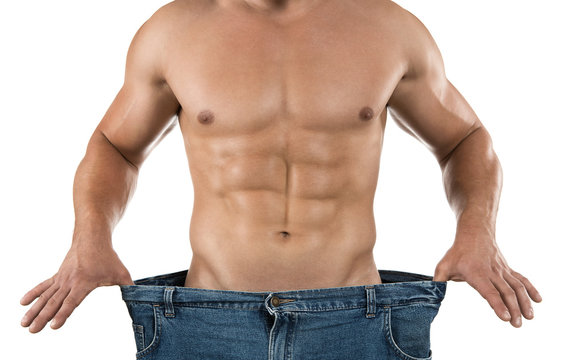 Weight loss, muscular man wearing too large jeans