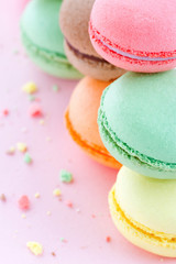 Colorful macaroons on pastel pink background