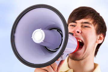 Young man shouting into the megaphone
