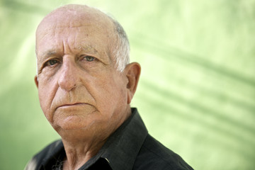 Portrait of serious old hispanic man looking at camera