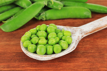 Sweet green peas on wooden background