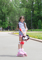 Little girl in roller skates at  park