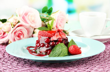 Tasty jelly dessert with fresh berries, on bright background