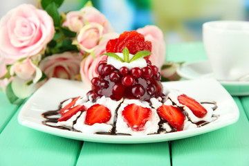 Tasty jelly dessert with fresh berries, on bright background