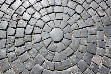 The roadway paved by a grey granite, background