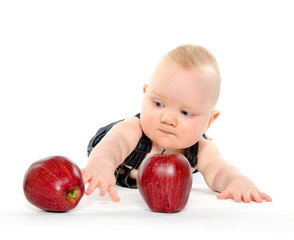 Fototapeta premium Baby boy playing with apples