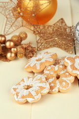 Christmas cookies and decorations on color wooden background