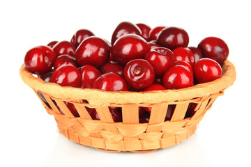 Cherry berries in wicker basket isolated on white