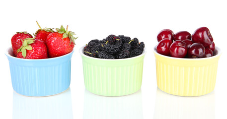 Ripe mulberries with cherry and strawberries in bowls isolated