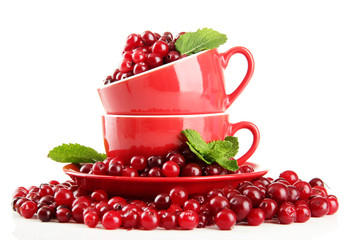 Ripe red cranberries in cups, isolated on white.