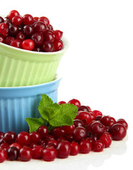 Ripe red cranberries in bowls, isolated on white.