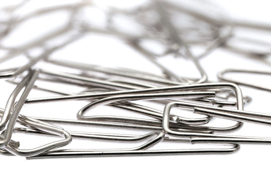 Lot of paper clips against a white background.Isolated.