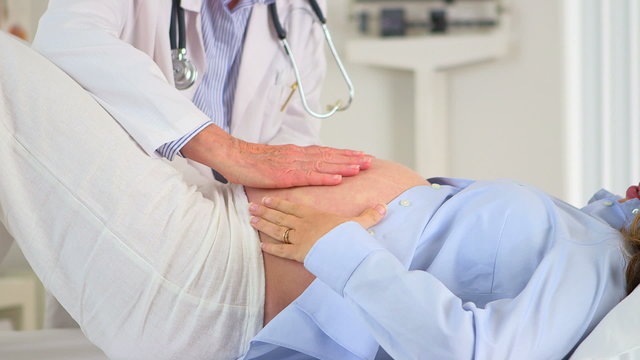 Doctor Examining preganct woman's belly