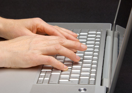 Female hands using computer.