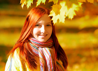 Young woman in autumn park.