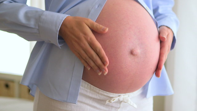 Pregnant mother rubbing stomach
