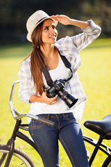 Fototapeta premium casual young woman with camera outdoors