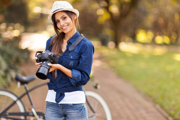 young female photographer with camera outdoors