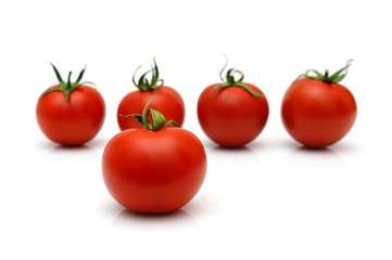 five cherry tomatoes with four in blur