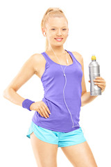 Young female in running outfit posing with a drink bottle