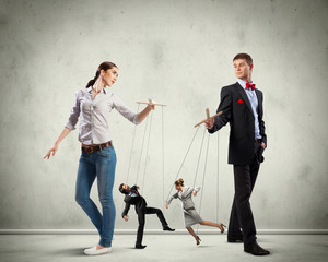 Businesspeople with marionettes
