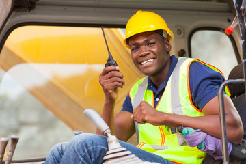 african bulldozer operator talking on walkie talkie