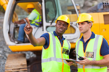 co-workers talking at construction site