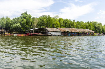 Fishing village in Thailand on bank of the river, boat berth