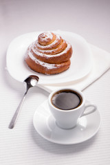 Cup of Black Coffee with a Sweet Bun