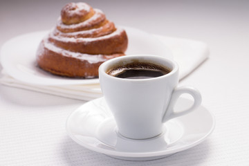 Cup of Black Coffee with a Sweet Bun