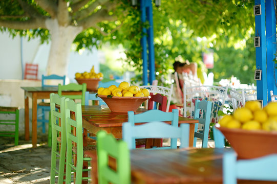 Fototapeta A dish of lemons in typical greek outdoor cafe