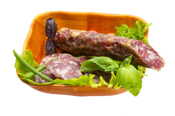 Ripe salami with salad, basil, onion and tomato