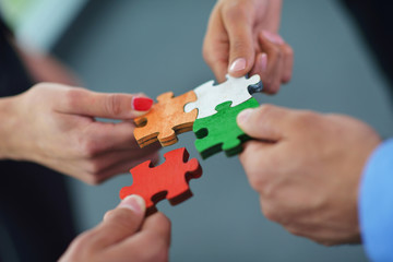 Group of business people assembling jigsaw puzzle - obrazy, fototapety, plakaty
