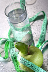 Healthy concept - apple glass of water and tape