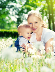 happy family. Mother and baby girl hugging on the nature