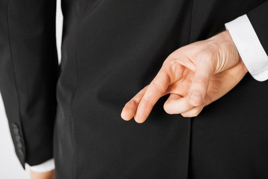 man with crossed fingers - Powered by Adobe