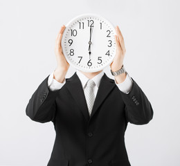 man with wall clock