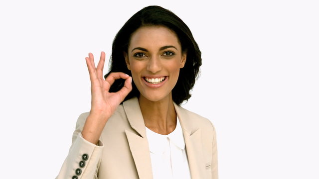 Businesswoman giving ok sign