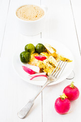Unusual breakfast with fried cutted egg, black coffee and vegeta