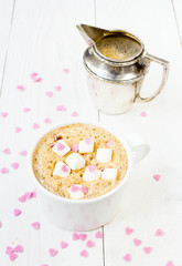 Cup of coffee with foam, marshmallow, milk mug and edible sweet
