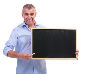 casual middle aged man presents blackboard