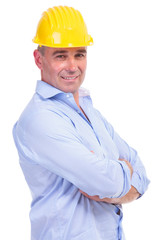 middle aged engineer holds hands crossed