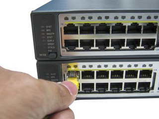 hand with ethernet cables connected to servers