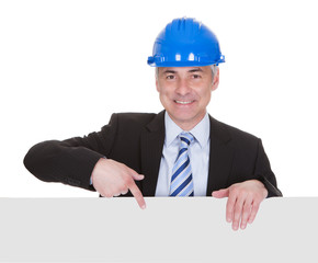 Mature Male Architect Holding Billboard