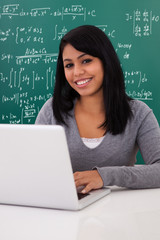 Portrait Of Female Student Using Laptop