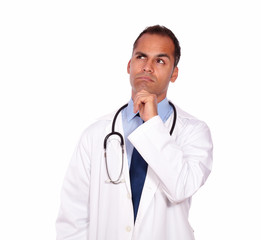 Fototapeta premium Pensive medical doctor looking up copyspace