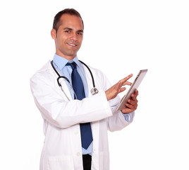 Smiling medical doctor using his tablet pc