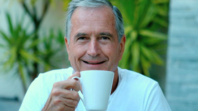 Retired man enjoying coffee outside