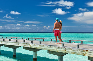 Couple on a beach jetty at Maldives