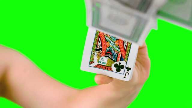 Hand shuffling and pushing cards towards camera